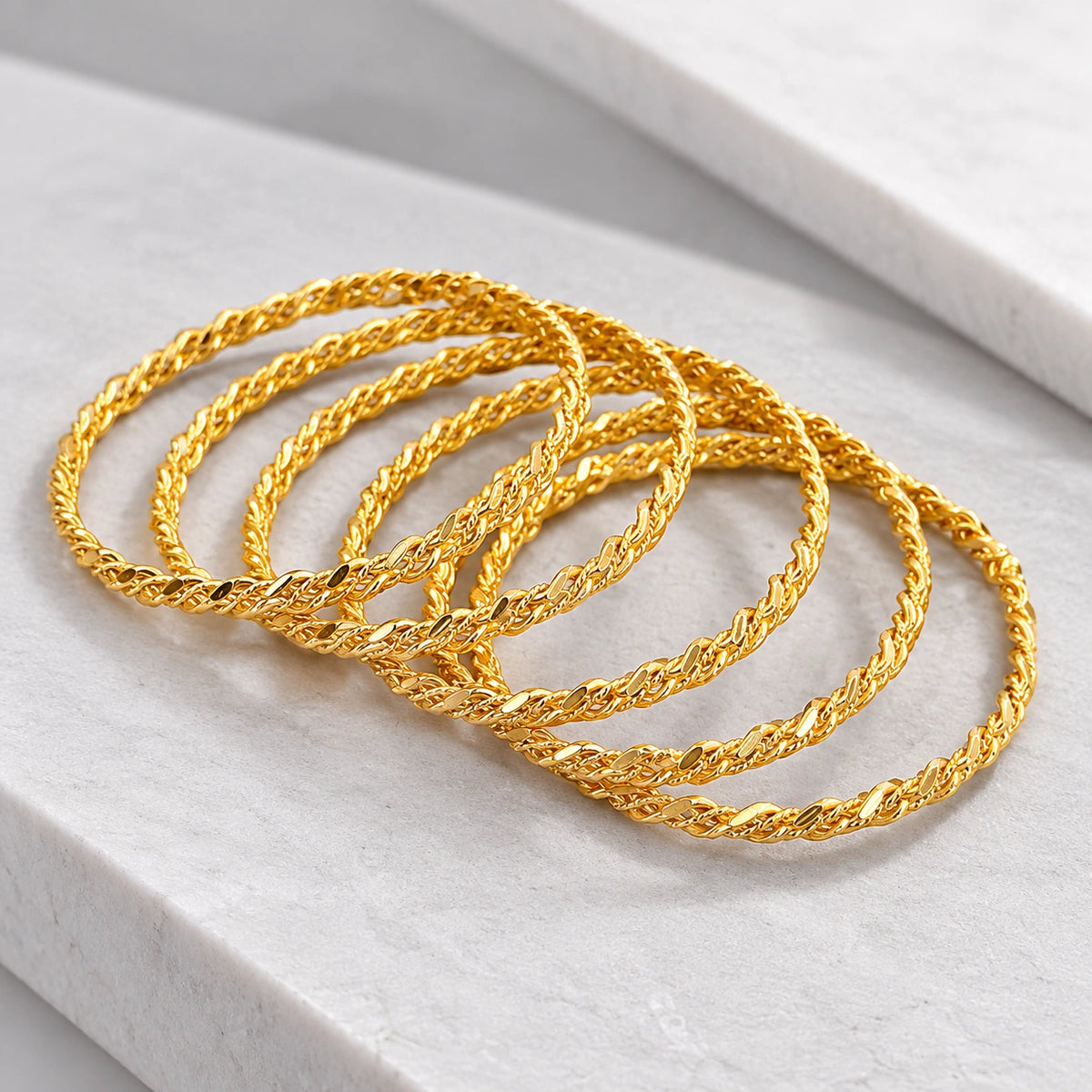 Stylish twisted gold-tone bangles for women
