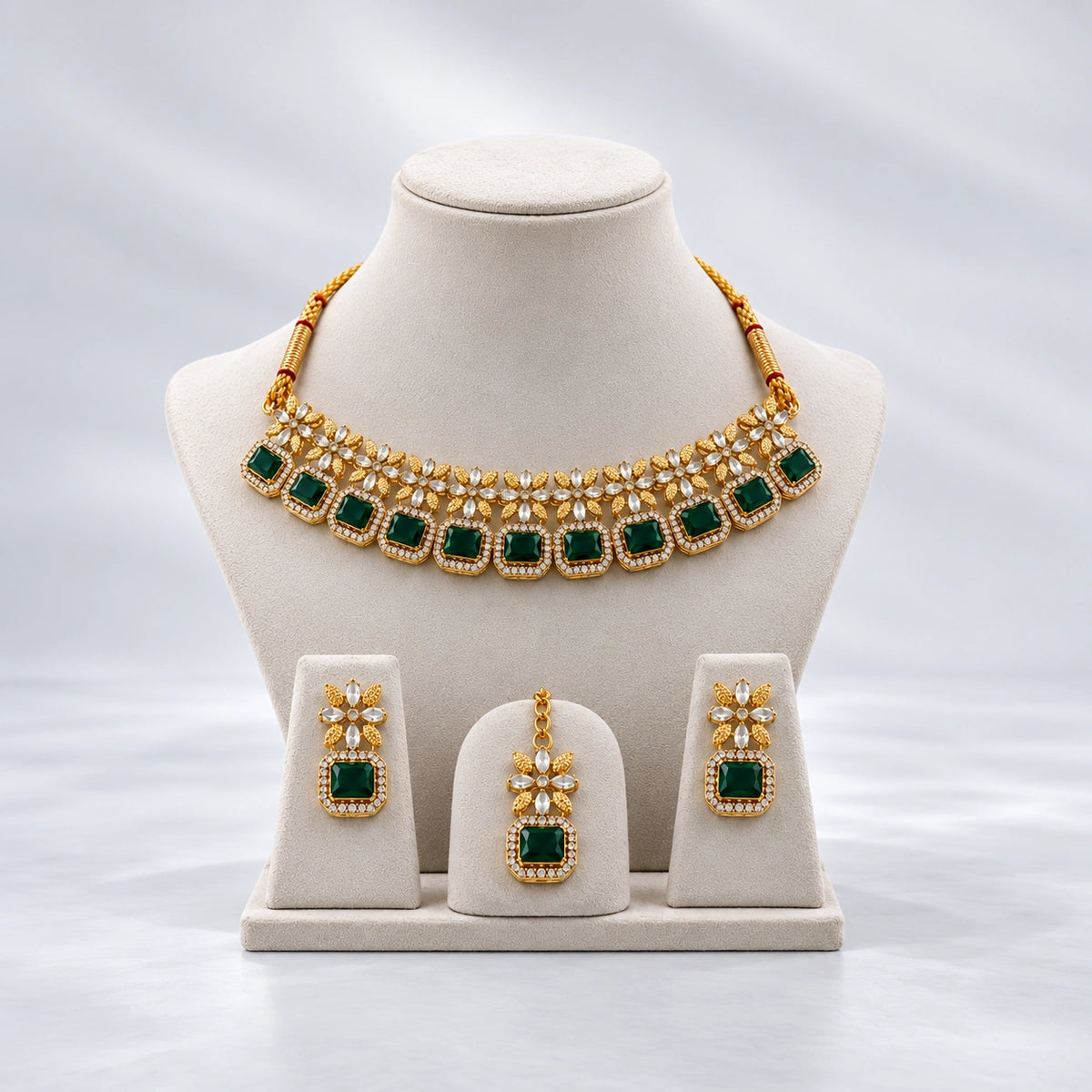 Elegant gold necklace set with green emerald-inspired stones